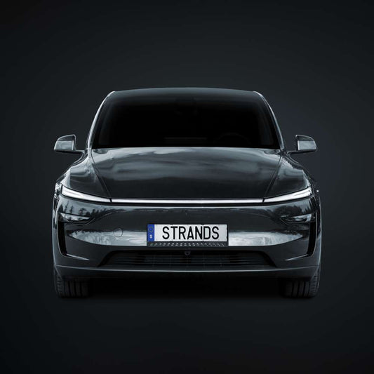 Tesla Model Y with SUV4x4CUSTOM Nuuk E-Line 20-inch black LED light bar kit installed on the front grille.